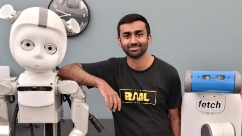 Georgia Tech robotics Ph.D. student Kartik Ramachandruni poses with a couple of his robot buddies.