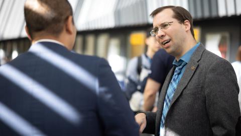 Georgia Tech OMSCS Executive Director David Joyner speaks with a colleague at a recent campus event.