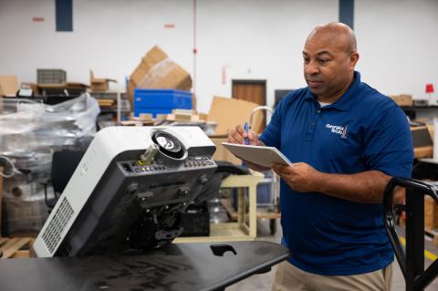 man looking at machine