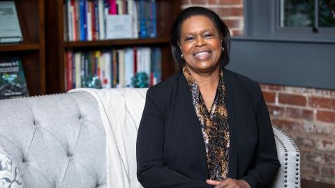 Image of Kaye Husbands Fealing on her couch in her office
