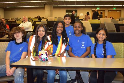 Middle school students pose with their robot at First LEGO League State Finals.