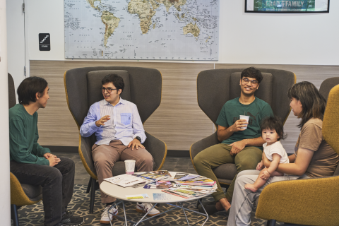 Students sit and talk to each other in the Graduate Living Center lobby