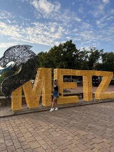 student in front of letters spelling METZ