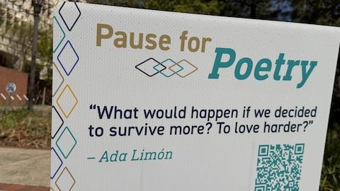 the sign reads "What would happen if we decided to survive more? To love harder?" - Ada Limón
