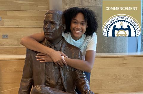 Deanna Yancey with 'The First Graduate,' which honors her grandfather, Ronald Yancey, EE 1965.