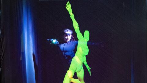 A student wearing motion capture gear and an AI-powered avatar dance together.