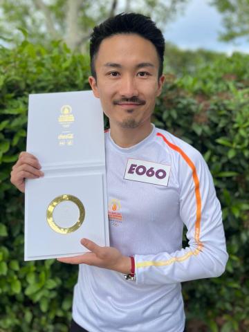 Photo of Louis Chen with a commemorative ring from the 2024 Paris Olympics torch relay.
