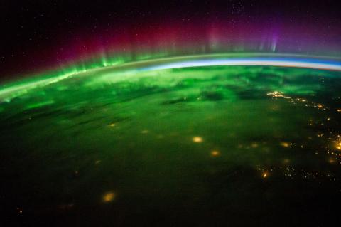 view of Earth from space, with auroras