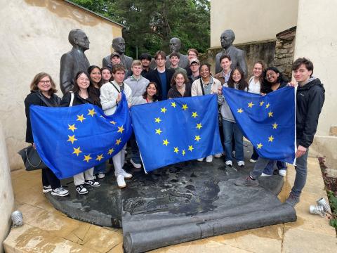 Group photo with three holding the EU flag.
