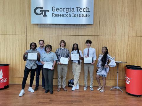 High School Students holding their internship completion certificates. Kala Jordan from IPAT pictured far right.