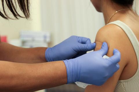 female student receiving a flu shot