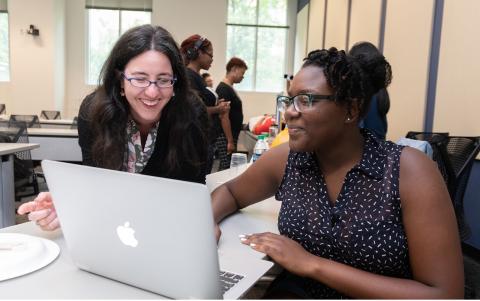 Hernandez (left) interacts with a participant in the program Pursuing Urban Sustainability at Home, a camp she helped facilitate.