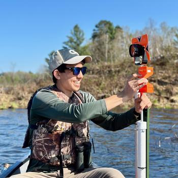 Eric Greenlee, a student from Georgia Tech, installs water-level sensors in lakes at Lac du Flambeau to help monitor wild rice beds. (Photo courtesy Naomi Blinick)