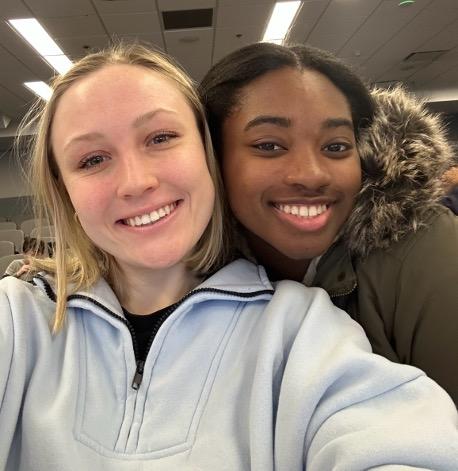 Two female students smile for a selfie.