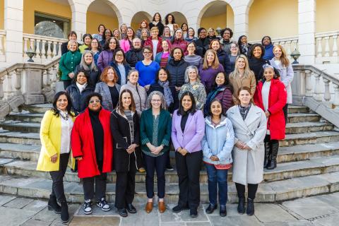 The Spring 2025 cohort of the HERS Leadership Institute, consisting of about 50 members, poses together on a set of stairs.