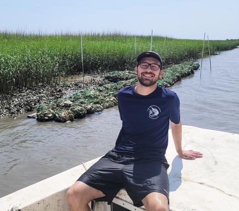 Tanner Lee (Georgia Tech, BS Biology '23) helped construct the oyster reef he observes from a boat as part of an undergraduate research project.