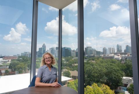 Dean Leslie Sharp in the Library, with a view of the Atlanta skyline through her window. 
