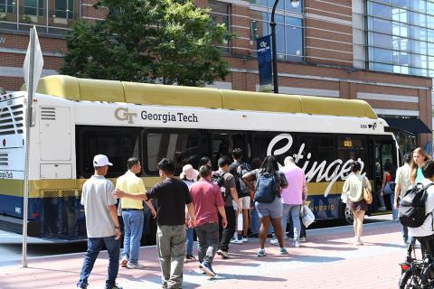 This image shows the campus community waiting to get onto the Stinger Gold Route bus.