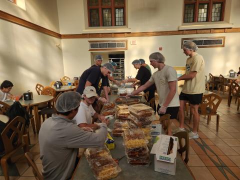 image of students packaging food at a table