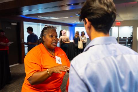 Woman speaks with a student.