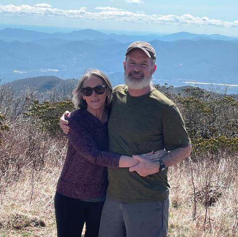 Rebecca Watts Hull and her husband Jonathan pose at a scenic overlook on a hiking trip.