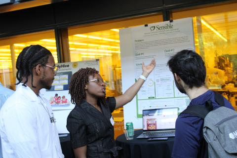 Creators of Sensible present their prototype to a fellow student.