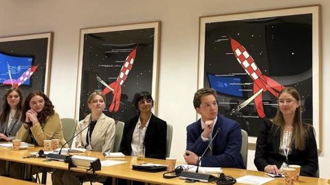 Several students participating in the EU study abroad program listen to a presentation.