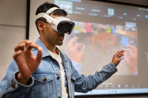 Georgia Tech student Yash Rajgure using an Apple Vision Pro headset device to demo his team's project.