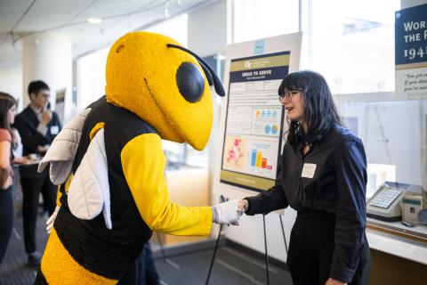 Ideas to Serve Showcase photo (participant and Buzz shaking hands)