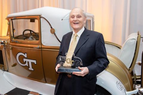 Man standing in front of the Georgia Tech Ramblin' Wreck.