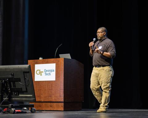 Vernard Martin speaking into microphone on theater stage