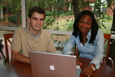 Adjoa Aka (R) and Adam Drozek (L), EWB-GT project leader and civil engineering student, review the group's water distribution plans for Cameroon.