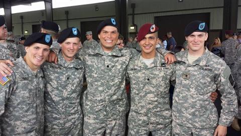 Five Army ROTC male students in camouflage at Georgia Tech with arms around each other.