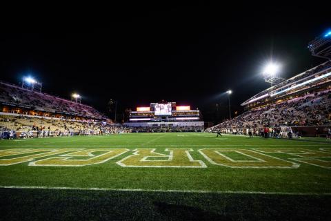 Georgia Tech football game at night during Covid-19 pandemic. Game held with social distancging protocols and masks required. 