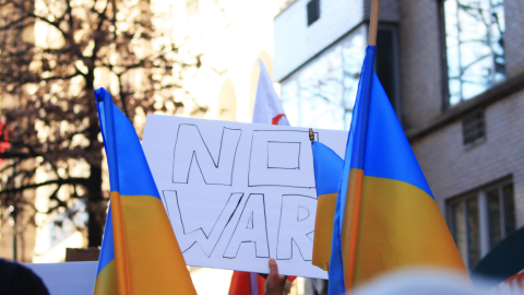 Protest against the war in Ukraine with Ukrainian flags and a sign reading "no war"