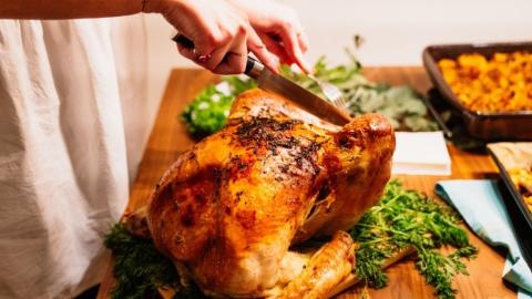 Cutting a turkey at a holiday dinner