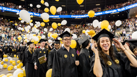 Graduating students with falling balloons at McCamish Pavilion for the fall commencement ceremony