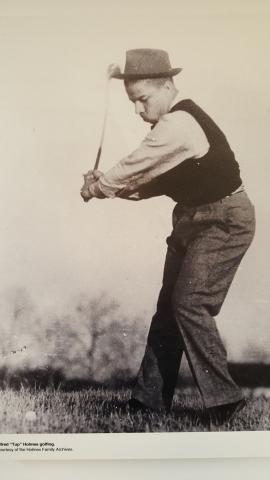 Alfred "Tup" Holmes playing golf.