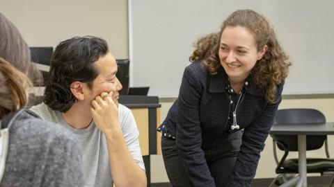A Georgia Tech student speaks with a professor during class.