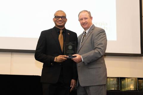 A photo of Will Jimerson receiving the Excellence Award