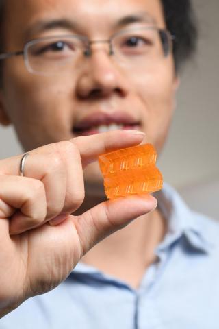 Researcher holding 3D printed origami