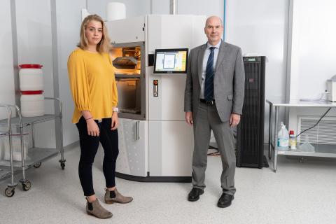 Researchers with 3D printing equipment