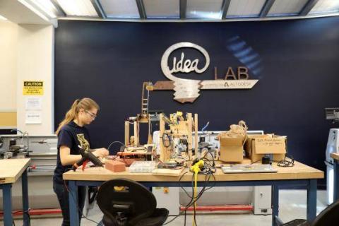 student working at a machine in the ideas lab