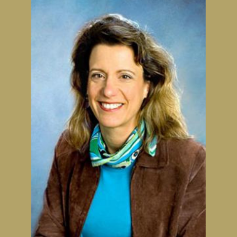 Kristie Macrakis headshot on gold bakcground