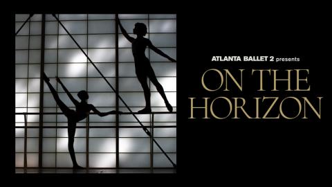 ATLANTA BALLET 2 ON THE HORIZON A male and female dancers are silhouetted against a backlit studio wall. The female is on the ground in arabesque en l'air and the man stands posed atop the barre in arabesque en terre.