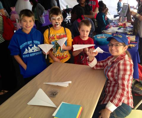 Frederick-Jaskiewicz teaching kids how to fold at the Bridewater Bookfest.