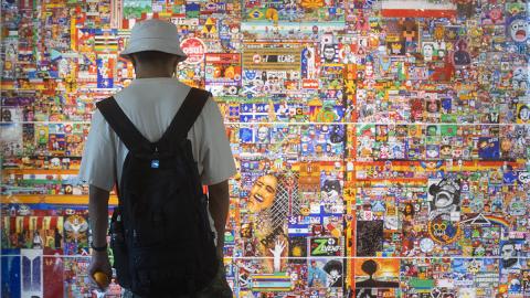 Student observing art display on campus