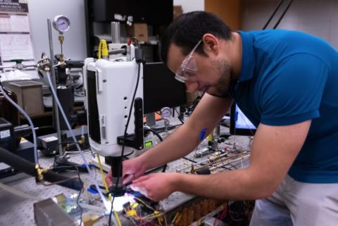 Daniel Lorenzini prepares to test a microchip as part of his liquid cooling system technology he developed at Georgia Tech. (Photo: Péralte C. Paul)