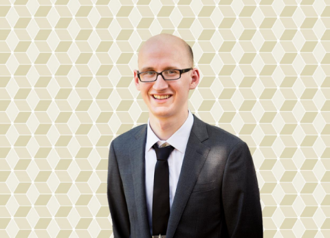 Daniel Dench headshot on new gold patterned GT background