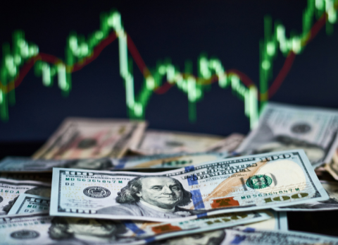cash money with a green chart behind it